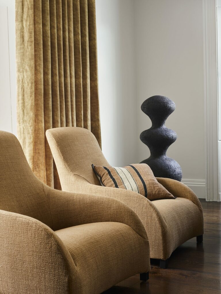 Curtain in 'Dahna' fabric, scorched earth, chairs in 'Warrior Cloth', horizon, striped linen cushion, all de Le Cuona