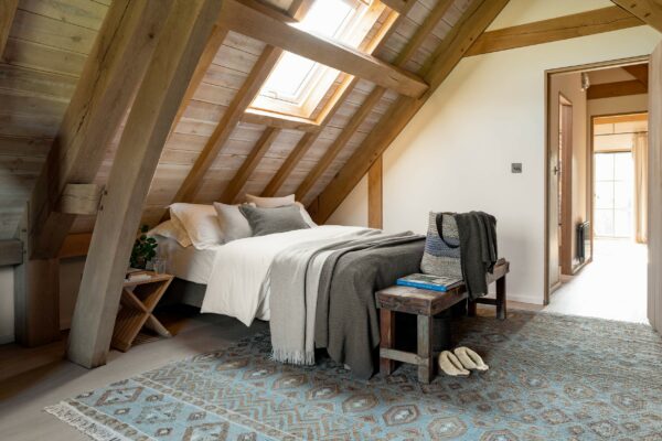 A bedroom showing the 'Una' rug by Sims Hilditch from Tim Page Carpets